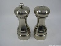 Front angled view of the Olde Thompson salt shaker and pepper mill showing their shape and size.
