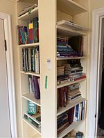 Corner bookshelf filled with assorted books