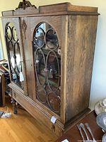 Full front view of cabinet showing overall structure and glass doors.