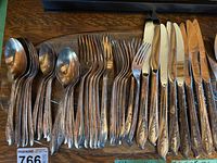 Full view of Rogers Springtime flatware pieces including spoons, forks, and knives.