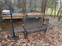 Overall view of glider bench, umbrella stand, one side table and planter stand