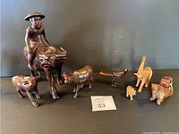 Overview of the full set showing a man riding a water buffalo, two smaller buffalo, a bird, elephant, baby elephant, and camel.