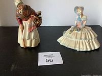Two porcelain Royal Doulton figurines 'Daydreams' and 'Grandma' shown from front