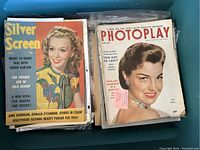 Plastic tub filled with color movie magazines including Silver Screen and Photoplay issues