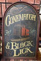 Full view of arched wood sign painted with 'Conemaugh & Black Lick', featuring red train caboose and phrases 'Fast' and 'Safe'.