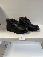 Side view of pair of black ladies comfort shoes size 38 XW, displayed on a white shelf.