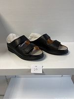 Side view of the ladies comfort shoes showing black color, two velcro straps, and open toe design.