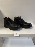 Side view of black ladies' comfort shoes showing the lace-up design and ankle height.