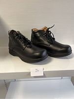 Side angle of black men's comfort shoes showing lace-up design, padded collar, and smooth upper material.