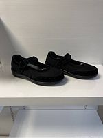Side angle view of both black Orthofeet ladies orthotic shoes showing design and mesh detail