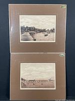 Two antique sepia tone engravings of Long Branch, matted and shrink-wrapped, one above the other showing waterside scenes with boats.