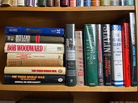 Shelf of 18 vintage and used hardcover books on intelligence agencies, policies, diplomacy, and historical political topics in generally very good condition with some browning spots visible on page edges.