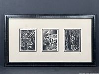 Framed set of three black and white woodcut prints by Lynd Ward displayed together in a single frame.