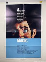 Full view of Magic movie poster showing ventriloquist dummy face and text with fold lines and blemishes.