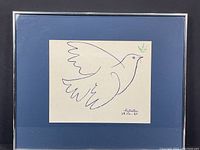 Framed blue and green silkscreen of a dove holding an olive branch by Pablo Picasso, overall frame view.