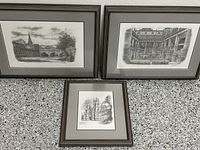 Photo showing all three framed prints together on a countertop, with York Minster smaller print centered below two larger prints showing a canal scene and courtyard pool.
