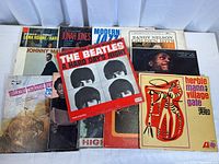 Photo showing 14 vinyl LP covers including The Beatles A Hard Day's Night and multiple jazz albums with worn covers.