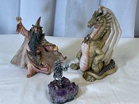 Photo showing all three figurines: dragon, large wizard, small wizard on mineral base