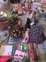 Overview of cat-themed items including figurines, faux flowers, fabric with paw prints, and other small decorative pieces.