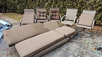 Outdoor lounge and rocking chairs showing cushion seating and metal frames
