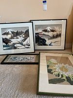 All four Asian prints arranged on the floor showing their frames and relative sizes.