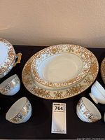 Soup tureen, serving platter, cups grouping