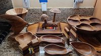 Overview of all wooden items including serving bowls, decorative mushrooms, bird figure, and salt and pepper shakers