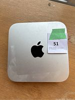 Top view of silver Mac mini showing Apple logo and surface scratches