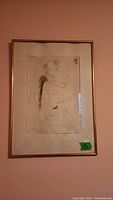 Framed artwork sketch hanging on a wall showing full view of drawing and frame.