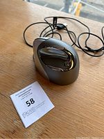 Top and side view of the wired ergonomic mouse showing ergonomic curved shape and USB cord.