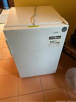 Closed view of the white Viking upright freezer showing the exterior and EnerGuide label.