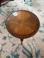 Birds-eye view of round coffee table showing the wood grain pattern and polished surface