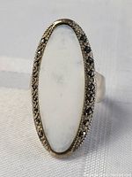 Front view of the vintage marquisette ring showing the elongated white agate center stone and surrounding marcasite stones.