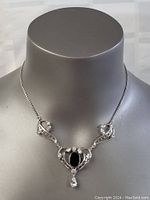 Front view of the sterling silver Art Deco necklace on a display bust showing the full length and design.