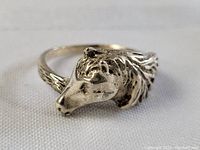Close-up front side view of the sterling silver horse head ring showing detailed facial features and textured band.