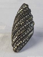 Front angled close-up of the vintage elongated marquisette sterling silver ring showing rows of clear rhinestones and pyramid studs.