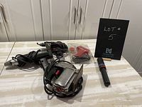 Photo of assorted electric power tools: jigsaw, electric drill, soldering gun in packaging, handheld torch.