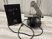 Side and top view of the Bexon Electric Belt Sander, showing work table, sanding belt, and power cord.