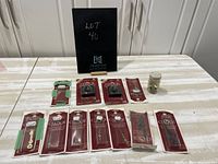 Image showing multiple packages of Clock Crafts clock hands and two packages of quartz clock movement pieces arranged on a table.