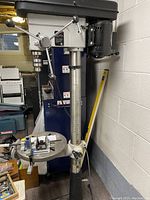 Front-left view of drill press showing column, head, and base