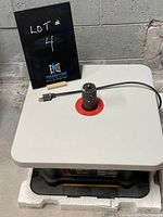 Oscillating spindle sander on original styrofoam packaging with visible spindle and power cord