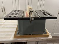 Full view of tabletop saw mounted on wooden base