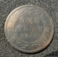 Reverse side of the 1859 Canada 1 cent coin showing denomination, date, and decorative border