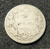 Reverse view of 1905 Canadian 25 cent silver coin showing denomination, maple leaves, crown and date.