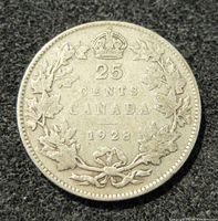Reverse side showing 25 cents denomination, Canada name, date 1928, and maple leaf wreath design.