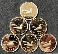 Six Canadian proof one dollar loon coins displayed on a dark surface, showing front (obverse) with loon design and year markings (1988, 1988, 1990, 1991, 1991, 1991).