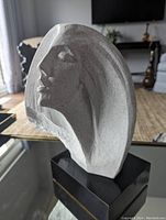 Front side of vintage Austin Productions abstract sculpture showing stylized female face and base.