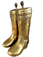 View of front and left sides of two brass cowboy boot bookends with embossed detailing and knob handles on top, in polished brass finish.