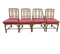 Four rattan dining chairs—one armchair and three side chairs—arranged in a row with red cushions