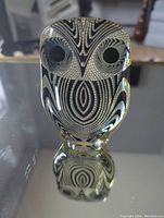 Front view of the Abraham Palatnik Lucite acrylic owl sculpture showing the op art black and white pattern and clear Lucite material with reflections.